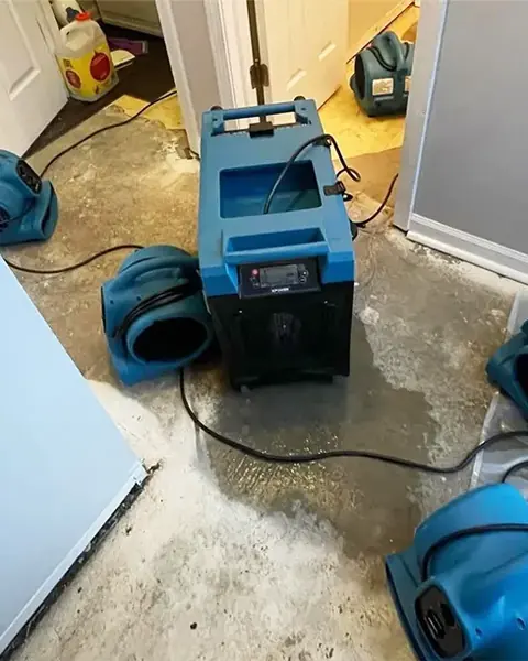 Air movers and a dehumidifier drying a room in a Sandy, UT home